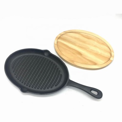 Cast iron oval griddle skillet grill pan with handle and wood trivet base